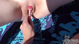 Tattooed babe with small tits is licking pussy in the nature, in the middle of the day