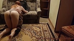 Red haired girl is kneeling on the floor while sucking her landlord's dick, to pay the rent