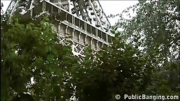 Slutty brunette is sucking dick and having a threesome, under the Eiffel Tower, during the day