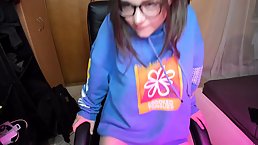 Flirty teen brunette with big, black glasses is sucking a fake dick in front of the camera