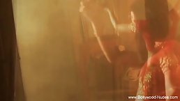 Indian brunette in a sexy, red dress is dancing and slowly getting naked to masturbate