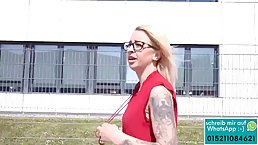 Tattooed German blonde in a red dress is getting fucked from the back, on the staircase