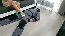 Babe in green sandals is gently rubbing her sub's rock hard dick to please him