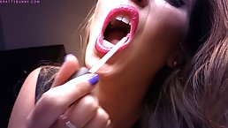 Charming babe is doing sexy stuff with her lips in front of the camera and enjoying it