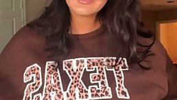 Stunning brunette is sucking a big, fake dick and rubbing it with her massive boobs