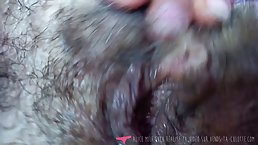 Mature woman is wearing a mask and black stockings while masturbating in front of the camera