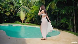 Irina Sivalna is posing naked next to the swimming pool, in the middle of the day
