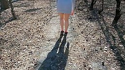 Kinky babe is wearing a mask while walking around the local park bottomless, during the day