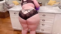 Big ass babe is posing in the kitchen while wearing nothing but erotic, black lingerie