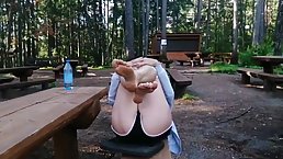 Kinky woman is showing her stinky feet in a local park, in the middle of the day