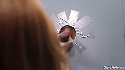 Red haired babe is getting fucked through a gloryhole and enjoying every single second of it