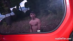 Mature brunette is sucking a younger guy's dick in a van and riding it a bit