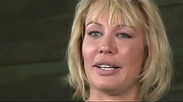 Blonde milf with a fat ass gets a rough fuck by two guys in a dungeon