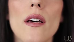 Girl with dark hair and exotic makeup shows off her tongue skills for those with a mouth fetish