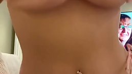 Busty blonde is posing topless in front of the camera, because it excites her a lot
