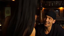 Slutty brunette in erotic, black stockings is about to suck dick in a local bar