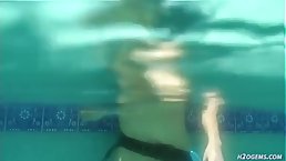 Small titted, German brunette is masturbating in the swimming pool, in the middle of the day