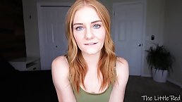 Blue- eyed chick with red hair is posing and teasing topless, in front of the camera