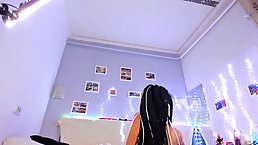 Small titted brunette with tattoos and pierced nipples is smoking while posing naked on live cam