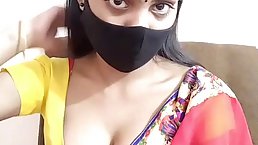 Indian brunette is posing and teasing in front of the camera, while alone at home