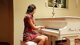 Young brunette pianist Oxana Chic showing her sexy body
