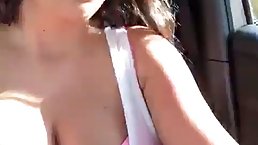 Busty brunette MILF masturbates in the car