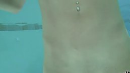 Fit busty brunette MILF masturbates underwater