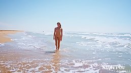 Beautiful brunette Baby Nicols is wet and horny on the beach