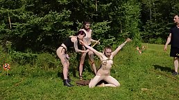 Kinky submissive slut dances between two face fucking doms while showered in piss