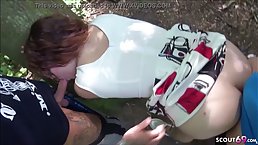 Busty redhead BBW with glasses gets fucked by two guys in the wood near the road